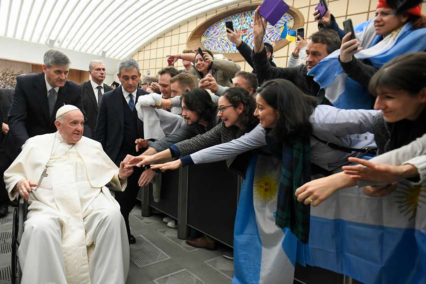 Argentina&#039;s flag is seen as Pope Francis greets people during his general audience in the Paul VI hall at the Vatican Dec. 14, 2022.