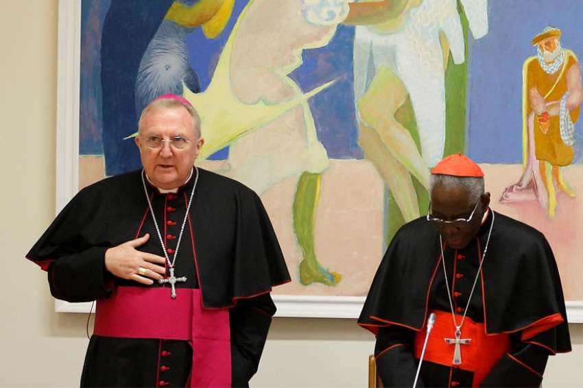 Archbishop Arthur Roche, secretary of the Congregation for Divine Worship and the Sacraments, is pictured with Cardinal Robert Sarah, prefect of the same congregation, as they pray with U.S. bishops at the start of a meeting at the Vatican in this Jan. 14, 2020, file photo. The Vatican announced May 27 that Pope Francis has appointed the English archbishop to lead the Congregation for Divine Worship and the Sacraments, succeeding Cardinal Sarah.