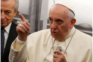 Pope Francis answers questions from journalists on his flight to Rome after a three-day trip to Turkey Nov. 30. 