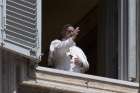 Pope Francis gives his blessing from the window of the library in the Apostolic Palace at the Vatican May 3, 2020.