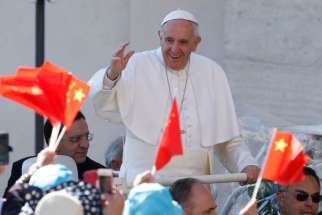  Pope Francis passes pilgrims waving China&#039;s national flag during his general audience in St. Peter&#039;s Square at the Vatican May 18.