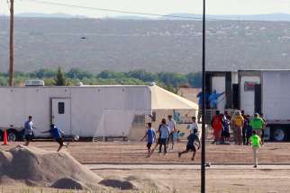  Children of detained migrants play soccer at a tent encampment near Tornillo, Texas, June 18. Image taken from Guadelupe, Mexico.