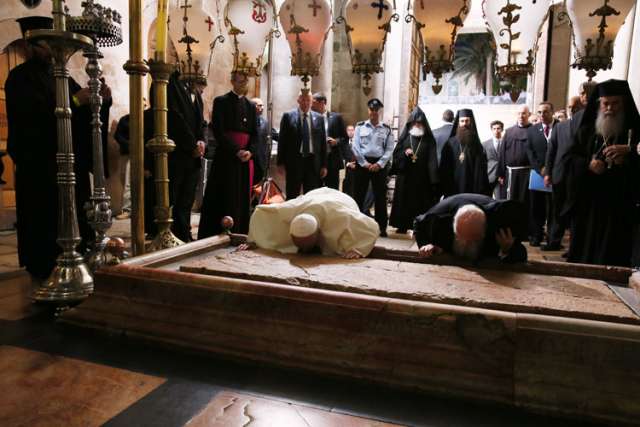 Pope Francis and Ecumenical Patriarch Bartholomew of Constantinople kiss the Stone of Unction in Jeusalem&#039;s Church of the Holy Sepulcher May 25. The two leaders marked the 50th anniversary of the meeting in Jerusalem between Pope Paul VI and Patriarch At henagoras.