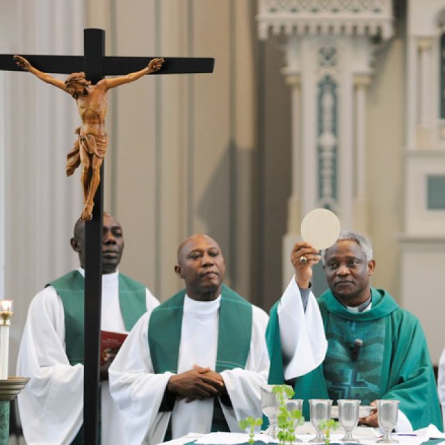 Cardinal Peter Turkson, president of the Pontifical Council for Justice and Peace, elevates the host while celebrating Mass June 18 in the Immaculate Conception Chapel at the University of Dayton in Ohio. Cardinal Turkson was at the university to attend the eighth annual International Conference on Catholic Social Thought: Renewing Mission and Identity in Catholic Business Education.