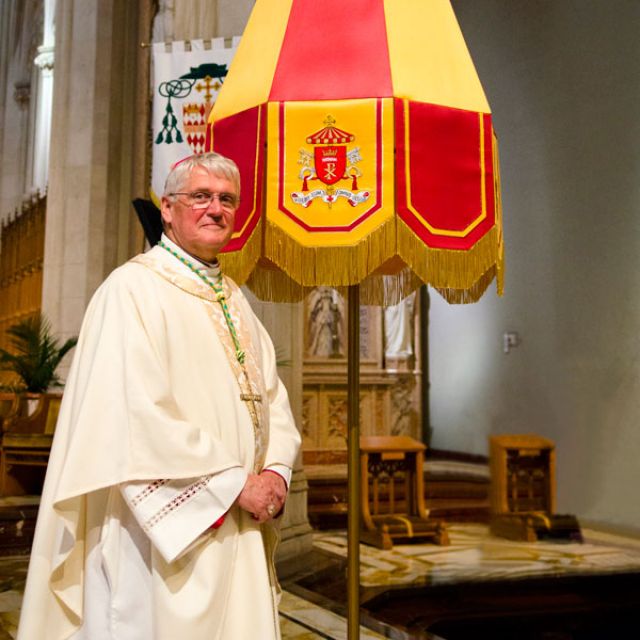 Hamilton Bishop Crosby standis in front of the ombrellino, a historic piece of papal regalia that would shield the Pope from the sun should he visit the church — at the Cathedral Basilica of Christ the King in Hamilton. The church was formally recognized as a minor basilica with a celebration June 23.
