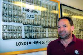 Paul Donovan, the recently retired president of Montreal’s Loyola High School, stands by the graduating class photo that contains his father Kevin, who was also a student at the storied Jesuit high school.