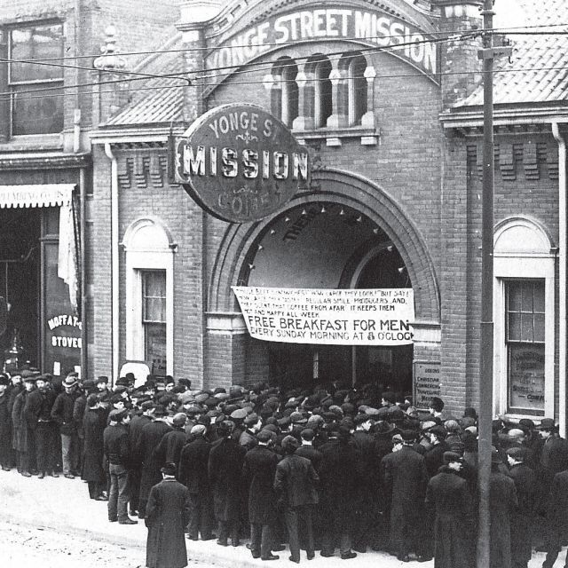 In this photo from 1912, men line up for a meal at the Yonge Street Mission.