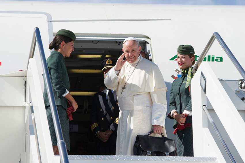 Pope Francis boards the plane in Italy for his trip to Colombia Sept. 6. 