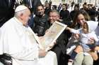 Pope Francis holds a portrait of himself while greeting visitors after his weekly general audience April 26, 2023, in St. Peter&#039;s Square at the Vatican.