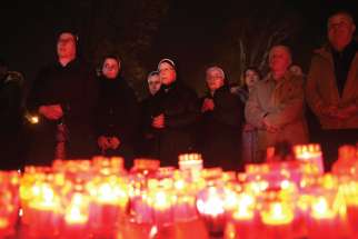 Bosnian nuns and others pray for former Bosnian Croat military chief Slobodan Praljak, who committed suicide Nov. 29, seconds after the verdict in the UN war crimes tribunal in Mostar, Bosnia-Herzegovina.