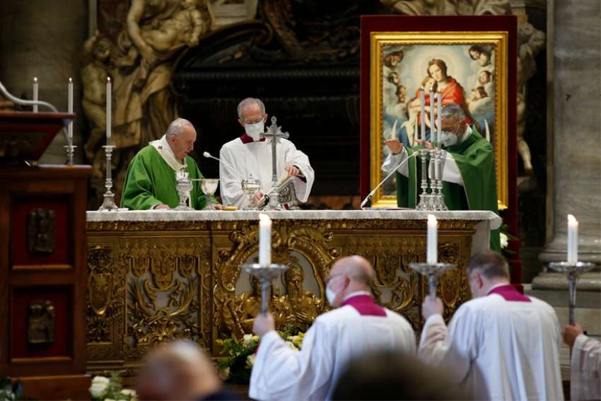 Pope Francis and German Bishop Franz-Peter Tebartz-van-Elst, right, delegate for catechesis at the Pontifical Council for Promoting New Evangelization, celebrate the Eucharist during a Mass marking World Day of the Poor in St. Peter&#039;s Basilica at the Vatican Nov. 15, 2020.
