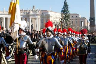 Swiss Guards are seen in a file photo arriving in St. Peter&#039;s Square to attend Pope Francis&#039; Christmas message and blessing &quot;urbi et orbi&quot; (to the city and the world) at the Vatican. Tasked with protecting the pope even at the cost of their own lives, members of the Swiss Guard are not just highly trained specialists in security and ceremonial detail, they also receive extensive spiritual formation, the guard&#039;s chaplain said.