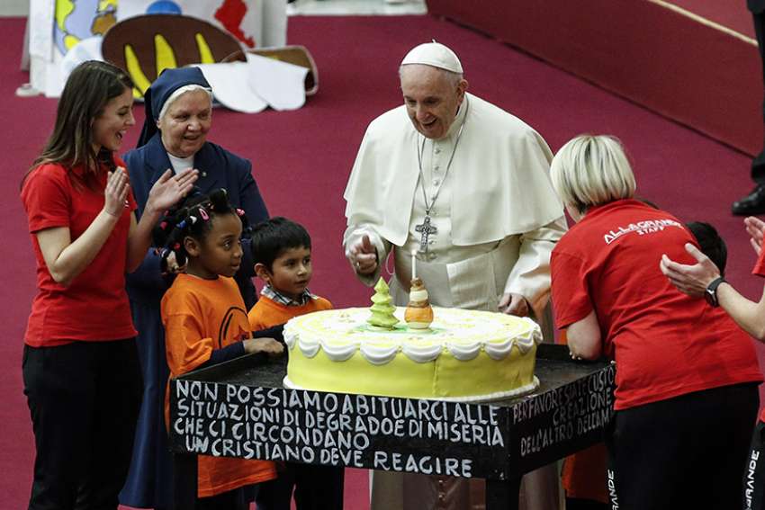  Pope Francis is presented with a cake on the eve of his 82nd birthday during a Dec. 16 audience with children and families from the Santa Marta Dispensary, a Vatican charity that offers special help to mothers and children in need.