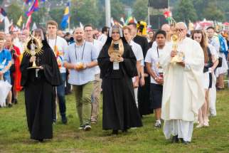 Relics of Sts. Faustina Kowalska and John Paul II are carried into the opening Mass for World Youth Day in Krakow, Poland, July 26.