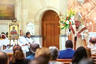 Cardinal Thomas Collins, under the watchful eye of an icon of St. Monica, speaks to a crowd gathered Sept. 24 at St. Augustine’s Seminary for the launch of the St. Monica Institute. Collins will be chancellor of the institute.