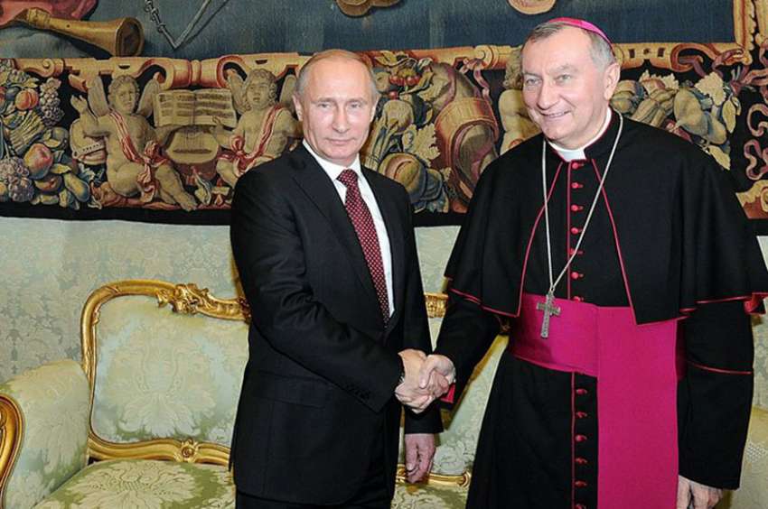 Cardinal Pietro Parolin greets Russian President Vladimir Putin at the Vatican in 2013. Cardinal Parolin will be visiting Russia later in August.