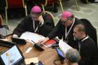 Members of the assembly of the Synod of Bishops use tablets to vote on the gathering&#039;s synthesis document Oct. 28, 2023, in the Paul VI Hall at the Vatican.