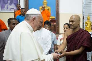 Pope Francis greets Buddhist monks in Colombo, Sri Lanka, Jan. 14. The pope paid an unscheduled visit to a Buddhist temple at the headquarters of the Maha Bodhi Society, responding to an invitation he had received the previous day from its head priest.