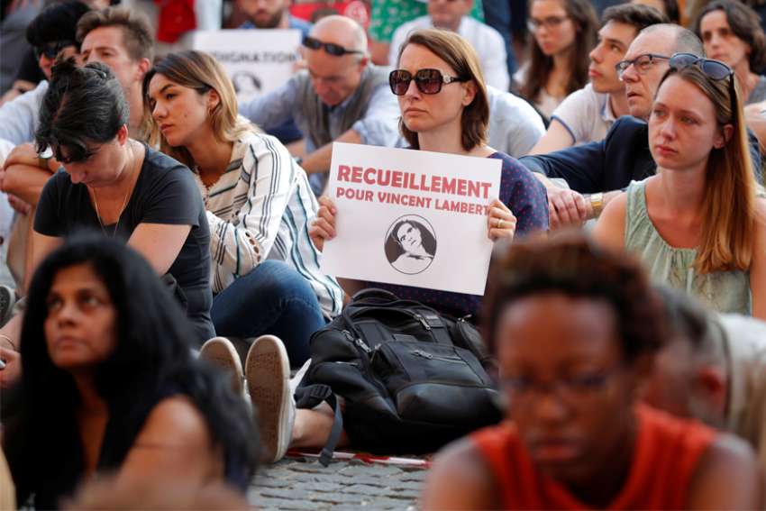 People demonstrate in Paris July 10, 2019, in support of Vincent Lambert, who suffered serious brain damage and had been in a deep vegetative state for more than a decade. &quot;Every life is valuable, always,&quot; Pope Francis tweeted after offering prayers for Lambert, a 42-year-old French man who died July 11, nine days after doctors stopped providing him with nutrition and hydration.