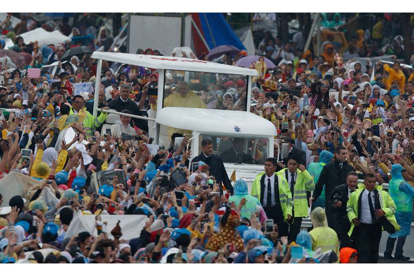 Pope Francis greets the crowd as he arrives to celebrate Mass at Rizal Park in Manila, Philippines, Jan. 18.