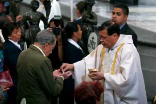 Cardinal Norberto Rivera Carrera of Mexico City distributes Communion during Mass in early May at Mexico City&#039;s Metropolitan Cathedral. Pope Francis will visit Mexico in February, marking the pontiff&#039;s first trip to the heavily Catholic country, said Cardinal Rivera.