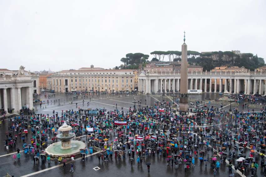  People participate as Pope Francis leads the Angelus from the window of his studio overlooking St. Peter&#039;s Square at the Vatican Sept. 27, 2020.