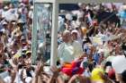 Pope Francis greets the crowd as he arrives to celebrate Mass in Los Samanes Park in Guayaquil, Ecuador, July 6. 