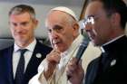 Pope Francis is pictured as he greets journalists aboard his flight from Rome to Maputo, Mozambique, Sept. 4, 2019. The pope will also visit Madagascar and Mauritius through Sept. 10. At left is Matteo Bruni, new director of the Vatican Press Office, and at right Msgr. Mauricio Rueda, papal trip planner.