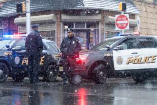 Police stand at the scene Dec. 11, 2019, of a gun battle that took place the day before involving two men around a kosher market in Jersey City, N.J. Six people, including a police officer and three bystanders, were killed in a furious battle that filled the streets of Jersey City with the sound of heavy gunfire for hours, authorities said.