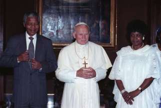St. John Paul II poses with Nelson Mandela and his wife, Winnie Madikizela-Mandela, in 1990 at the Vatican.