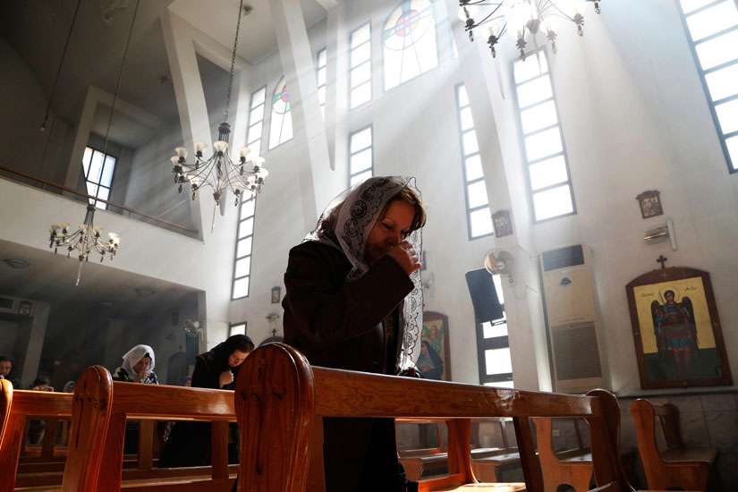 An Assyrian woman prays at a church in Damascus March 1 during a special Mass for Assyrian Christians abducted by Islamic State fighters. Christian leaders again called for help for Assyrian Christians as Islamic State militants stepped up their attacks against their towns in northern Syria.