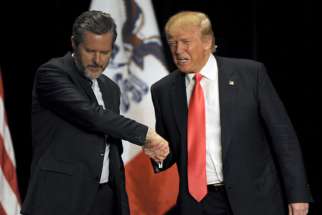 Republican presidential candidate Donald Trump, right, shakes hands with co-headliner Jerry Falwell Jr., leader of the nation&#039;s largest Christian university, during a campaign event at the Orpheum Theatre in Sioux City, Iowa, on Jan. 31, 2016.