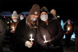 People in Boulder, Colo., attend a candlelight vigil March 24 to pray for victims of a shooting that left 10 dead at a grocery store.