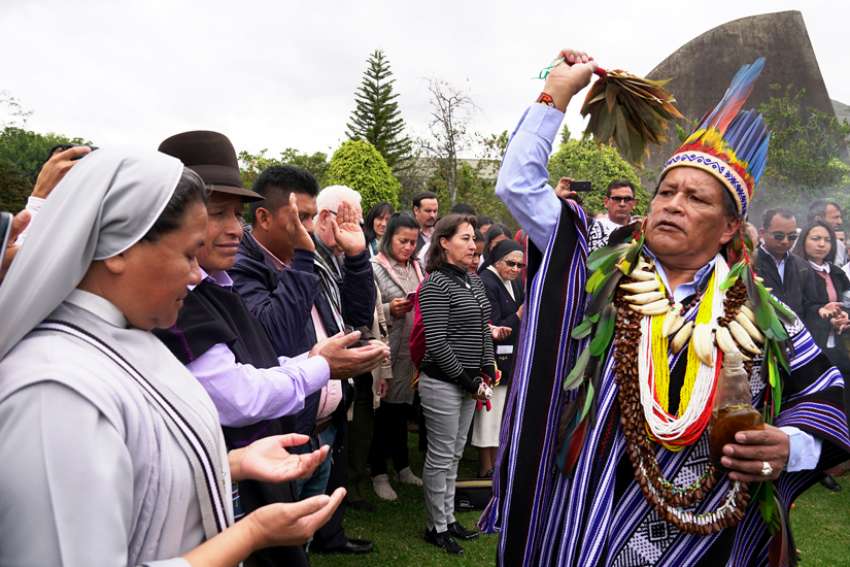 Isidoro Jajoy, a shaman from Colombia&#039;s Inga tribe, blesses people in Bogota Aug. 14, 2019, during a preparatory meeting for the October Synod of Bishops for the Amazon.