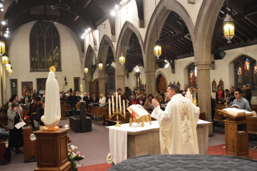 Fr. Peter Turrone presides over Mass for the Our Lady of Fatima feast Oct. 13 at St. Thomas Aquinas Church. Turrone credits the intercession of St. Joseph for a gift that will allow him to renovate the church. 