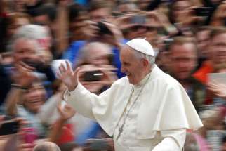 Pope Francis greets the crowd during his general audience in St. Peter&#039;s Square at the Vatican May 11.