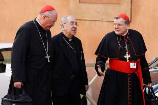Cardinals Timothy M. Dolan of New York, Stanislaw Rylko, president of the Pontifical Council for the Laity, and Raymond L. Burke, prefect of the Supreme Court of the Apostolic Signature, arrive for the morning session of the extraordinary Synod of Bishop s on the family at the Vatican Oct. 14. 