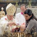 Pope Benedict XVI baptizes one of 16 infants during a Mass in the Sistine Chapel at the Vatican Jan. 8.