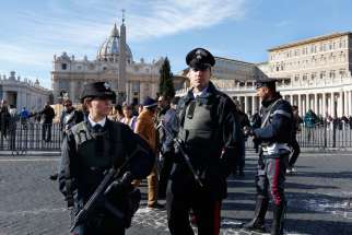 Members of the Carabinieri, the Italian military police force, stand guard as people leave Pope Francis&#039; Angelus blessing in St. Peter&#039;s Square at the Vatican Nov. 22.