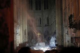 Smoke rises around the altar inside Notre Dame Cathedral in Paris as a fire continues to smolder early April 16, 2019. Officials said the cause was not clear, but that the fire could be linked to renovation work. 