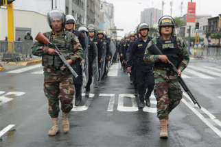 Police keep watch outside Congress after Peruvian President Martin Vizcarra shut down Congress in Lima Sept. 30, 2019.