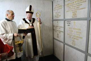 Then-Archbishop Timothy M. Dolan of New York prays at the tomb of Archbishop Fulton J. Sheen at St. Patrick&#039;s Cathedral in New York City in 2009 after celebrating a memorial Mass for the prelate. 