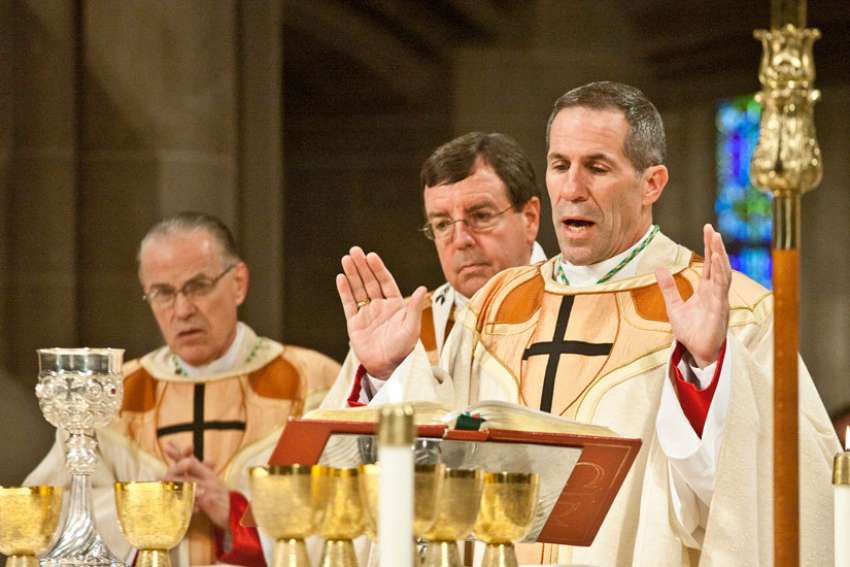 Detroit Auxiliary Bishop Michael J. Byrnes, right, concelebrates Mass in 2011 at the Cathedral of the Most Blessed Sacrament during his episcopal ordination. Pope Francis appointed the bishop as coadjutor archbishop of Agana, Guam, whose leader is under a Vatican investigation for the alleged sexual abuse of minors.