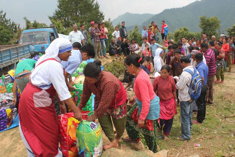 A member of the Missionaries of Charity helps distribute relief items to earthquake victims May 16 in the mountains overlooking Kathmandu Valley in Nepal. Toronto donors faced tough decisions when it came to giving to disaster relief, local charities and fundraising initiatives.
