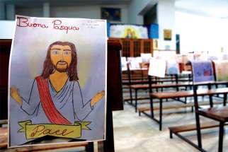 One of the many drawings done by children decorates one of the empty pews in a church during Holy Week in Catania, Italy, where public Masses have been prohibited because of the coronavirus.