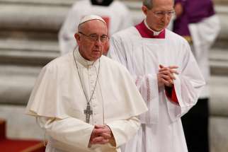 Pope Francis walks to a confessional during a Lenten penance service in St. Peter&#039;s Basilica at the Vatican March 17.