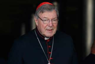 Australian Cardinal George Pell leaves the opening session of the extraordinary Synod of Bishops on the family at the Vatican Oct. 6, 2014.