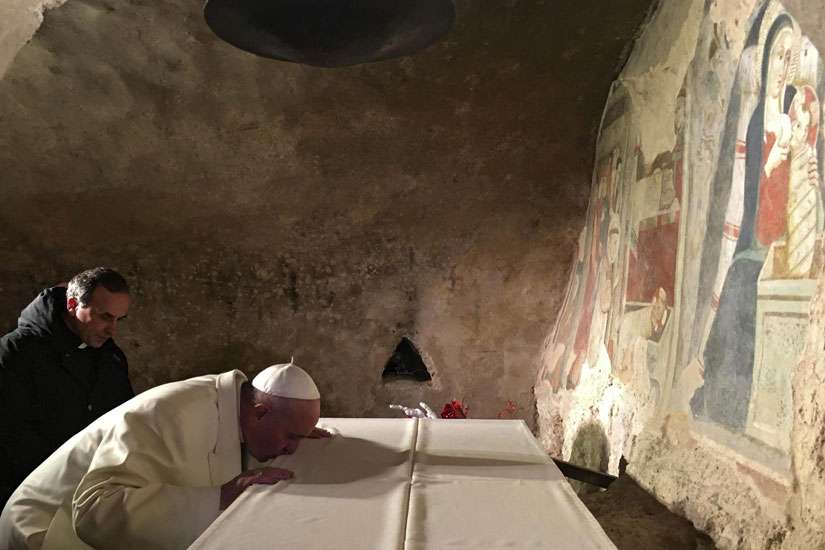 Pope Francis prays in front of a Nativity scene during a Jan. 4 surprise visit to the Franciscan shrine in Greccio, Italy.