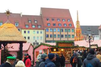 People walk through the Christmas market Dec. 18 in Nuremberg, Germany. Dating back to 1628, it is one of the oldest Christmas markets in Germany.