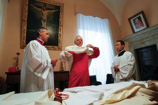 Washington Cardinal Donald W. Wuerl puts on his vestments as he prepares to take possession of Rome&#039;s Basilica of St. Peter in Chains in 2011. Pope Francis has accepted the resignation of Cardinal Wuerl as archbishop of Washington but did not name a successor. 